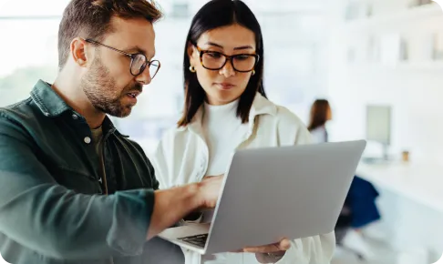 Man and woman looking at laptop